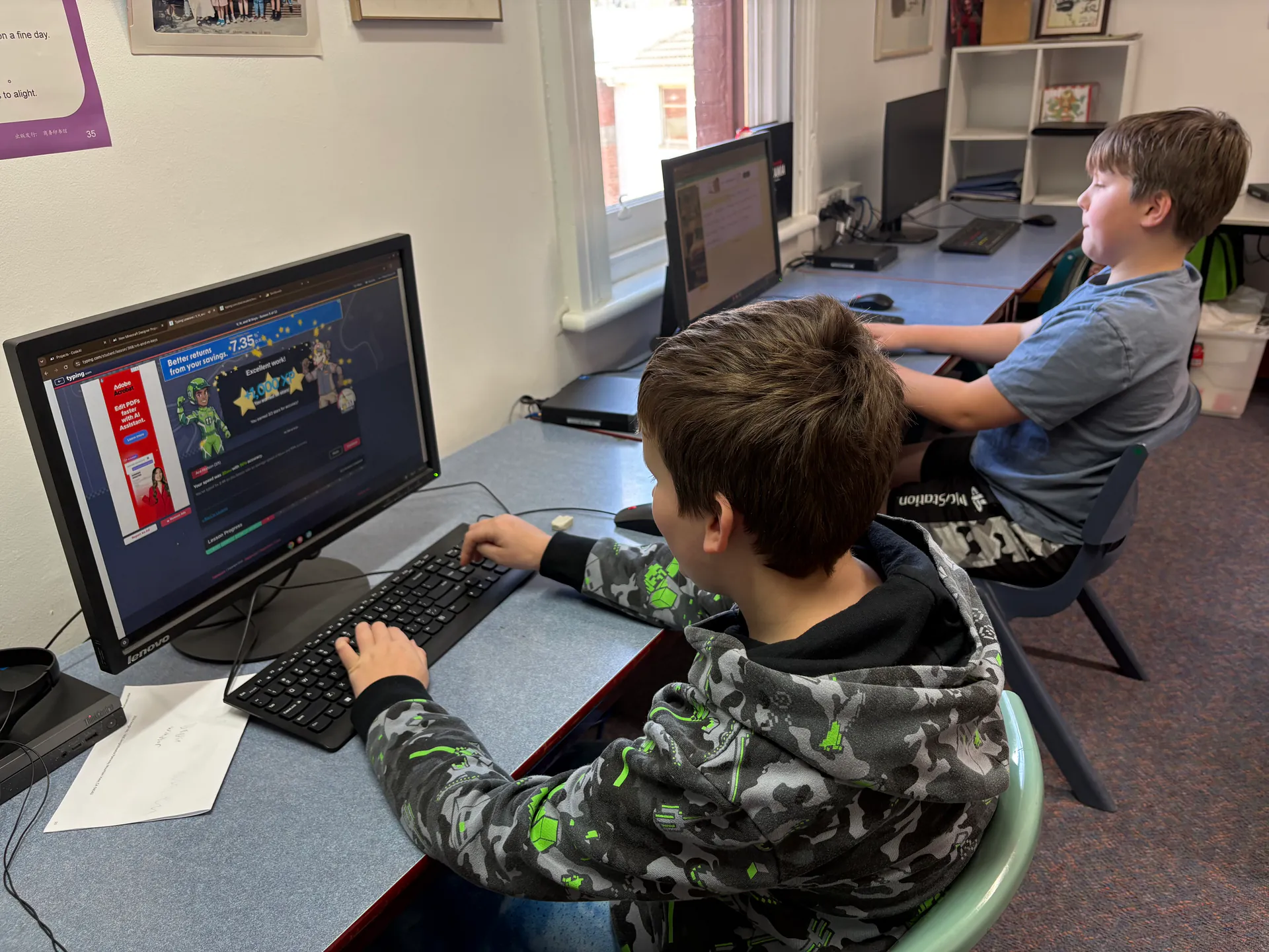 Students learning with computers in the classroom