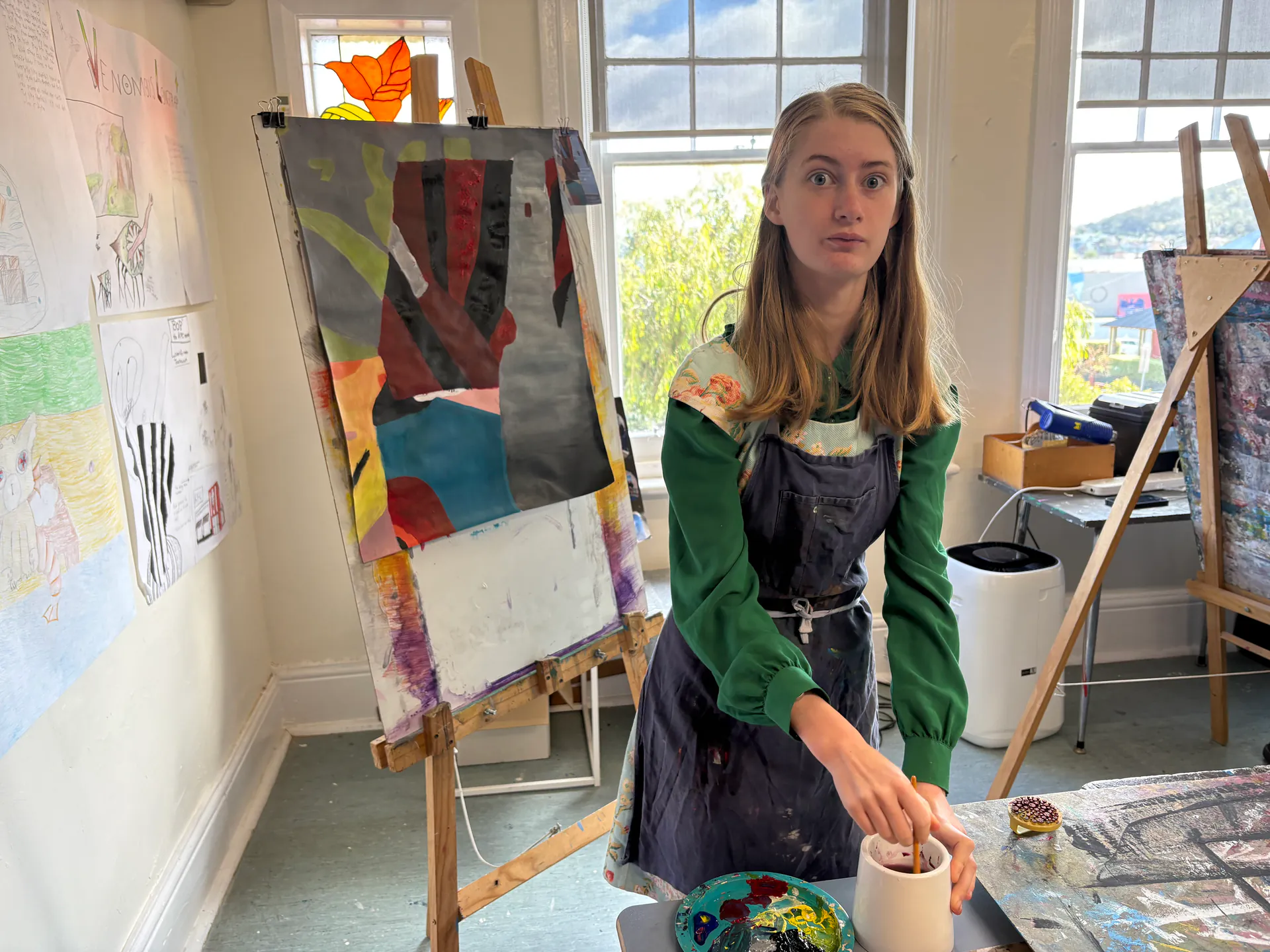 Student creating artwork in the art studio